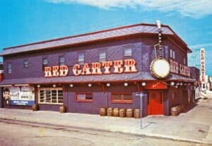 Exterior view of Red Carter restaurant with large neon sign.
