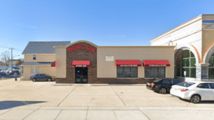 Exterior of Dong Sin restaurant with red signage and awnings.