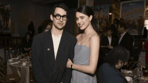 A young man and woman posing together at an event.
