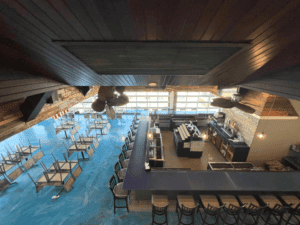 Interior view of a modern cafe with bar seating and tables.