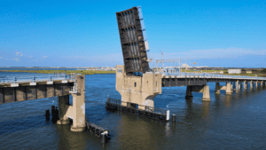 An open drawbridge over a waterway on a clear day.