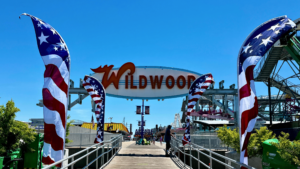 Entrance sign of Wildwood boardwalk with clear blue sky.