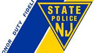 Partial view of a New Jersey State Police badge and flag.
