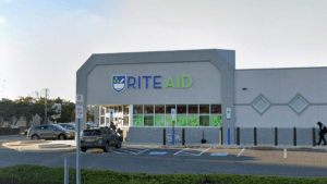 Rite Aid pharmacy storefront with cars parked outside.
