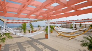 A rooftop terrace with hammocks and potted plants under a wooden pergola.