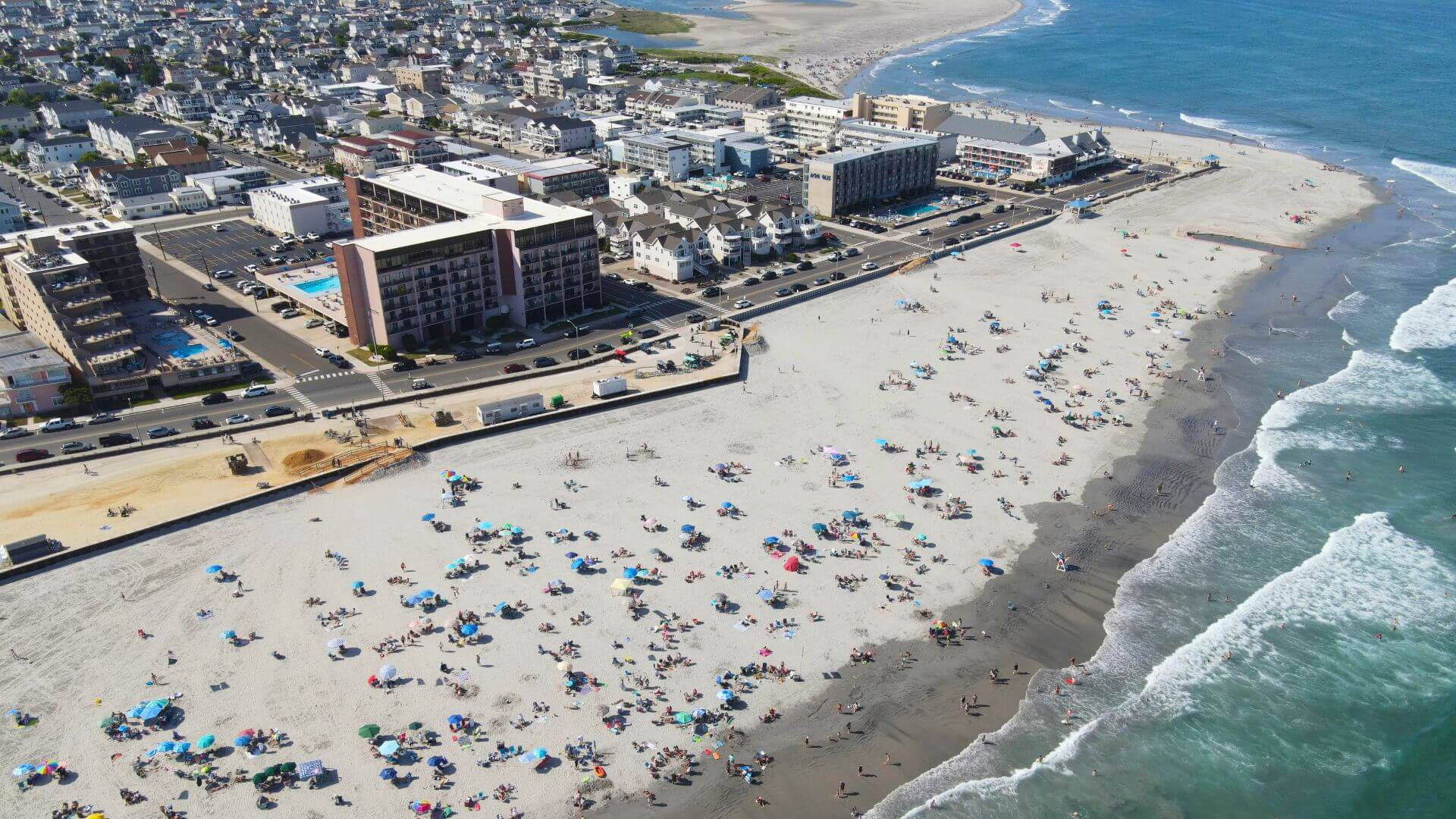 Aerial view of crowded beach and buildings.